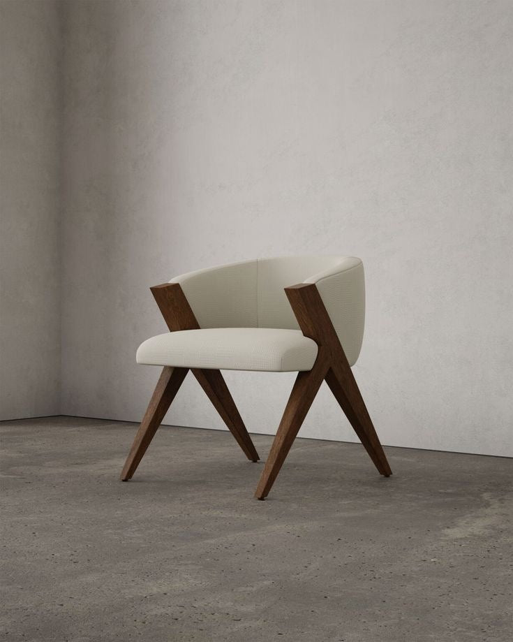 Modern chair with wooden legs and white cushioned seat against a gray wall.