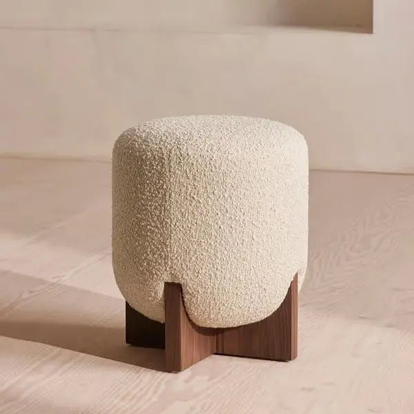 Textured stool with wooden base on a neutral background