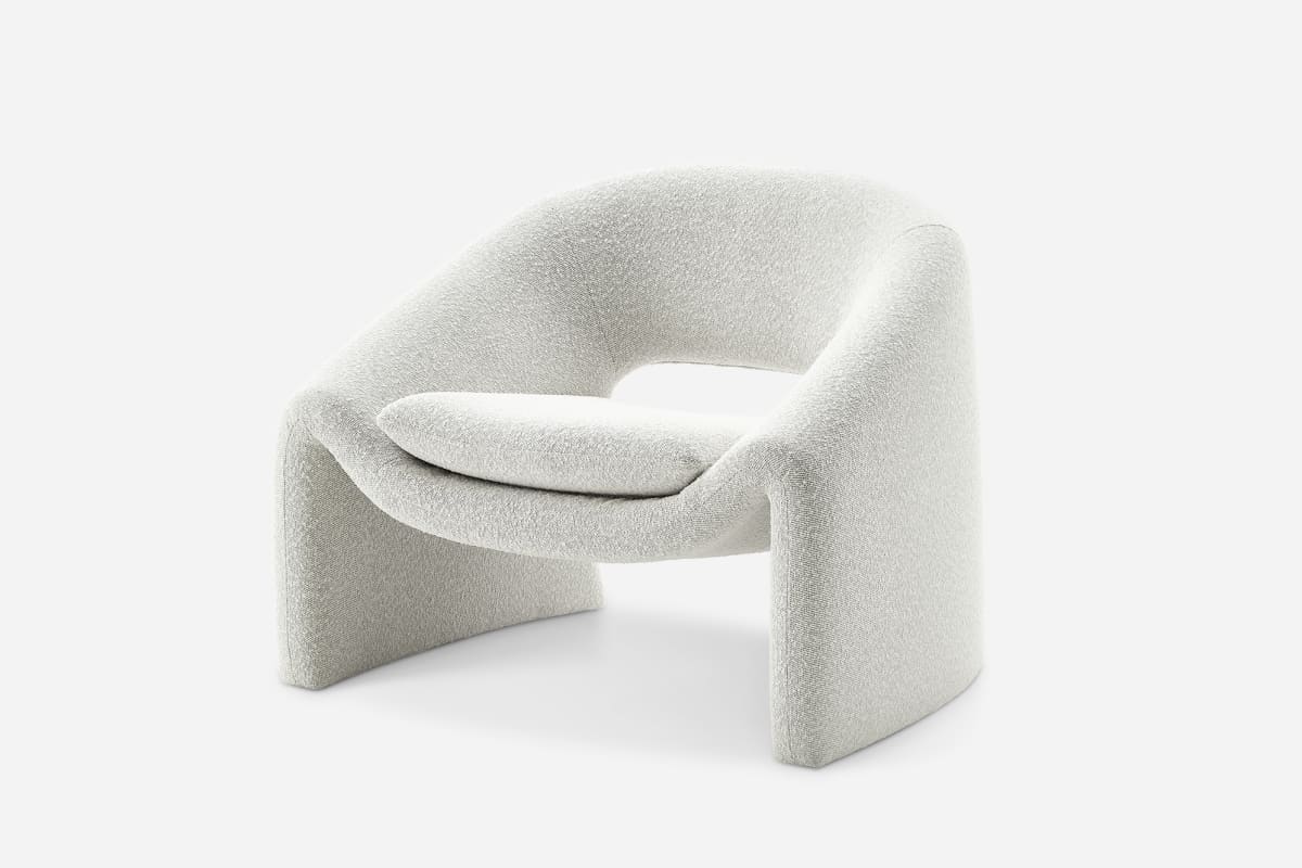 Modern chair with a textured white finish on a light gray background