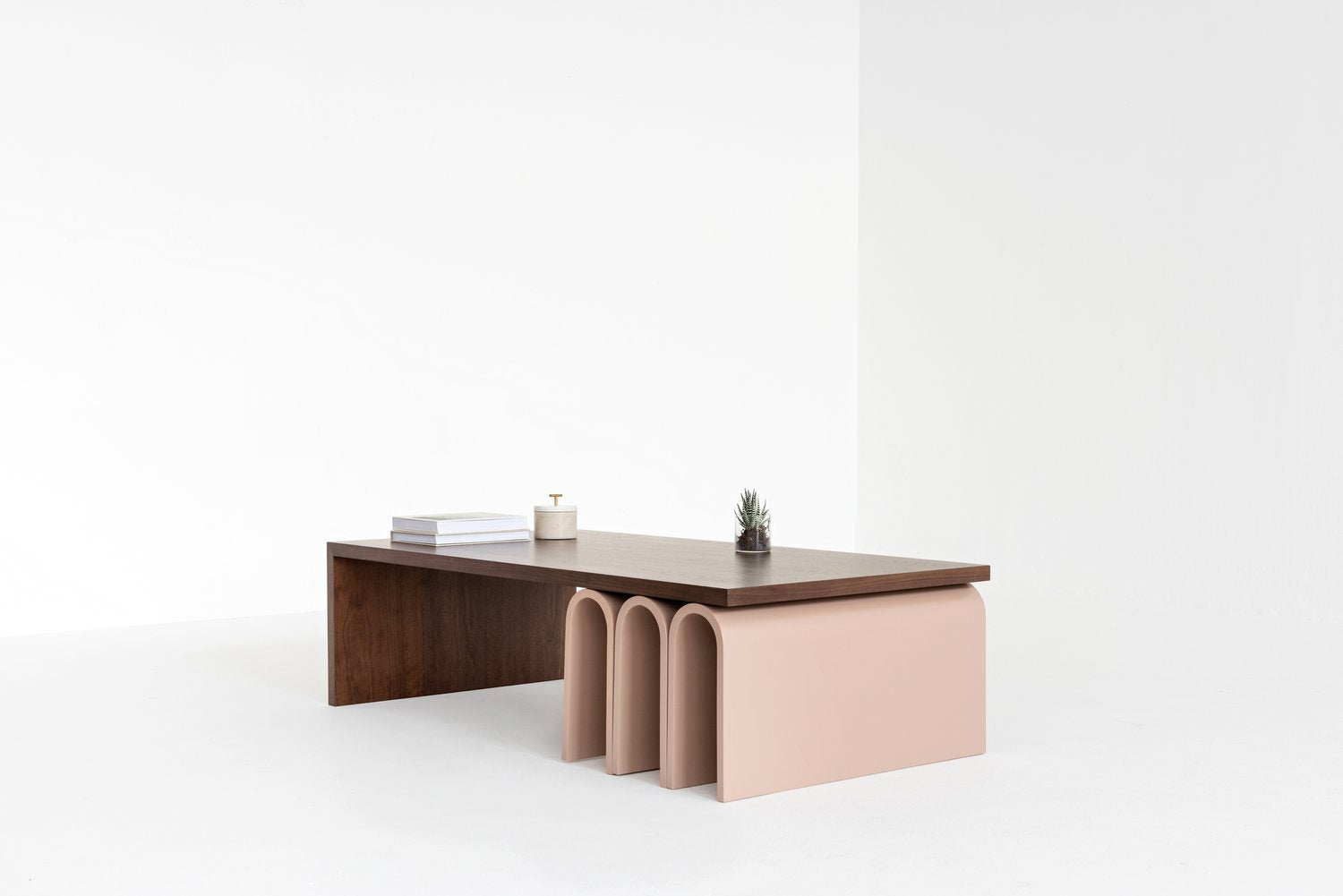 Modern Center table with a wooden top and pink base on a white background