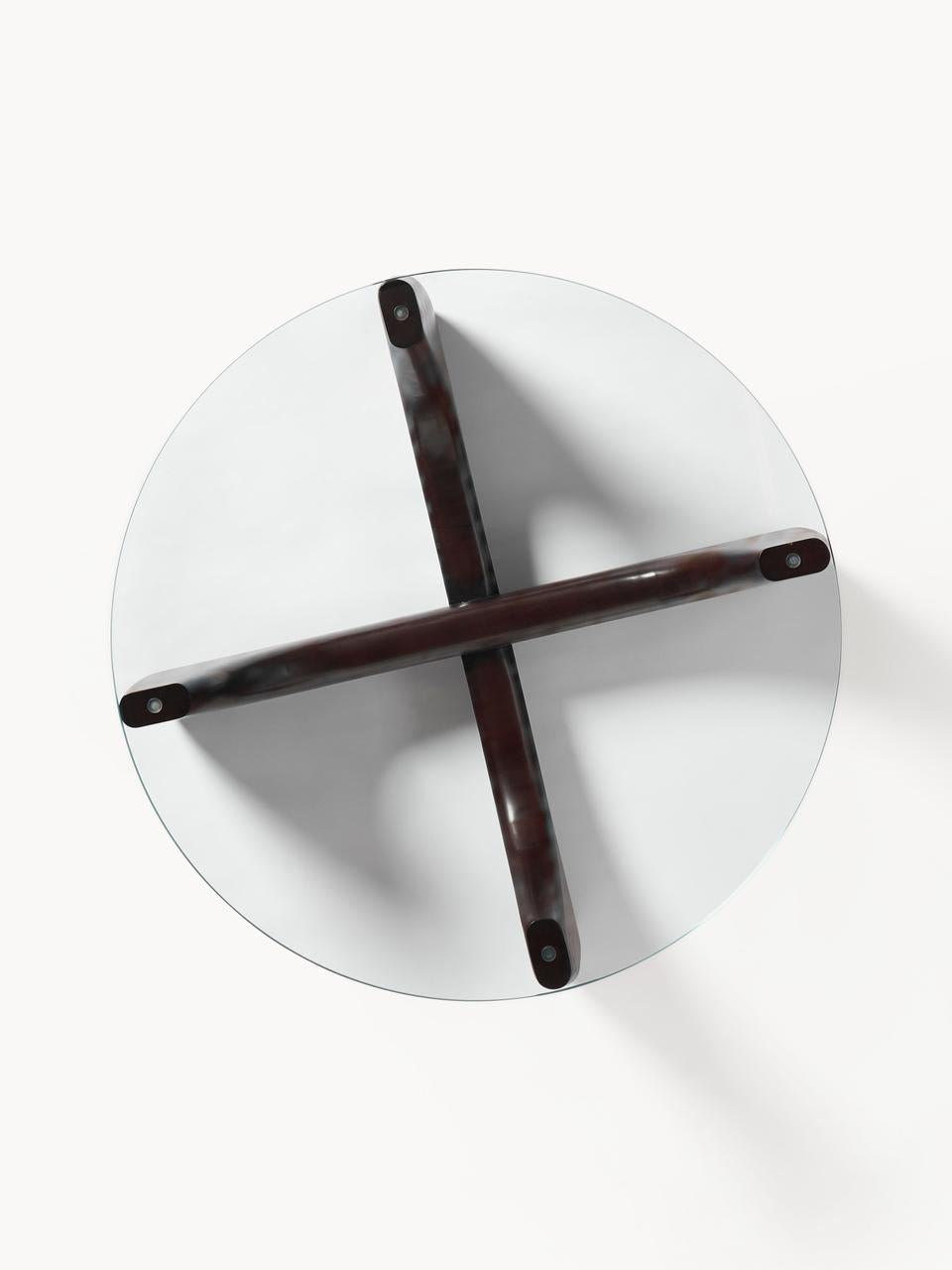 Round white table with dark wood crossbar on a white background