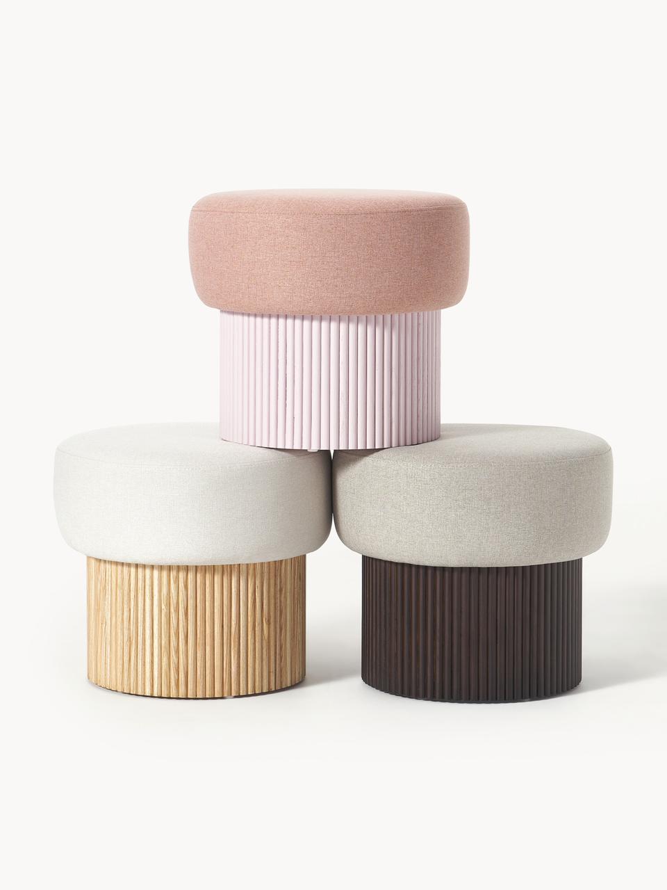 Four cylindrical stools with different colored tops and bases on a white background