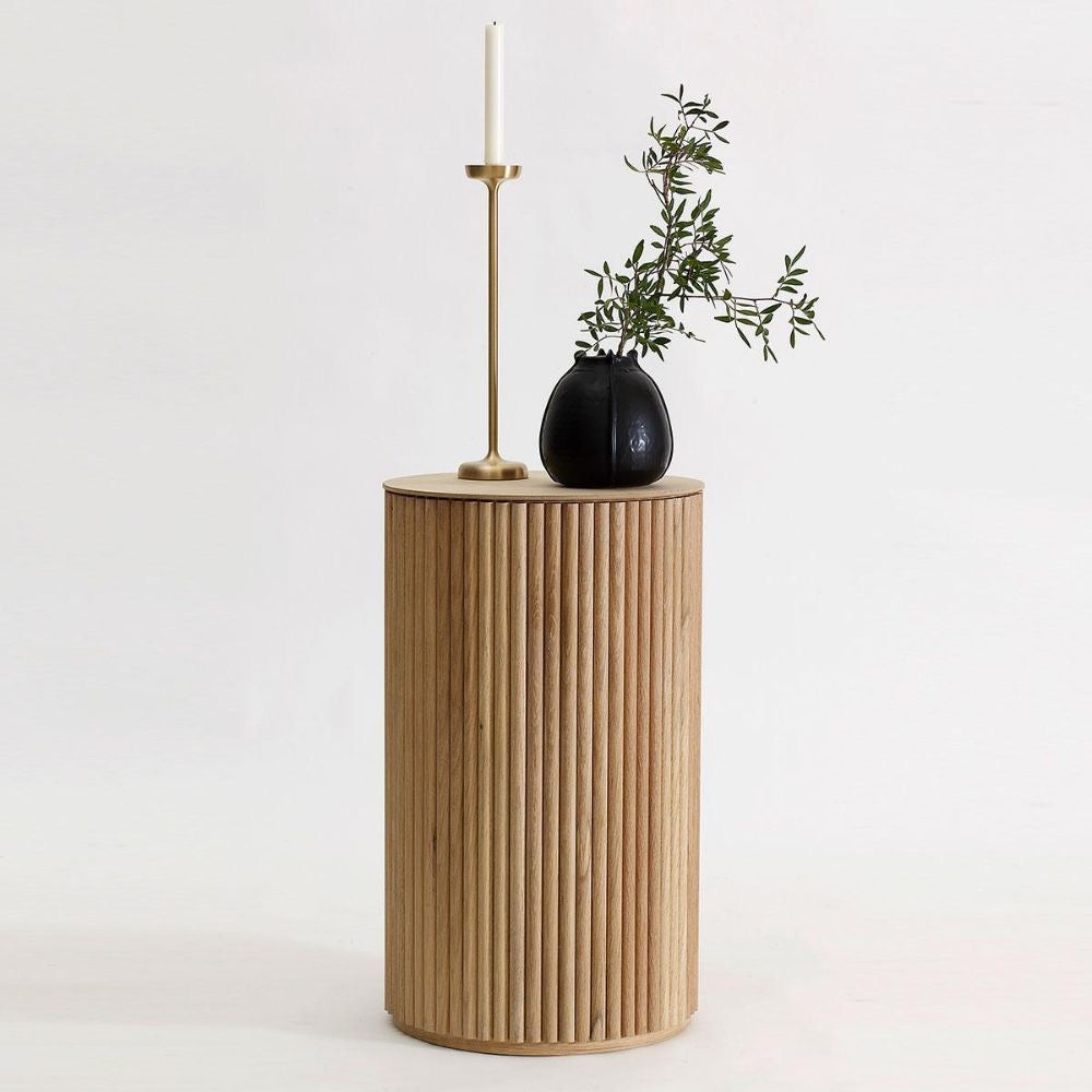 Wooden side table with a black vase and candle on a white background