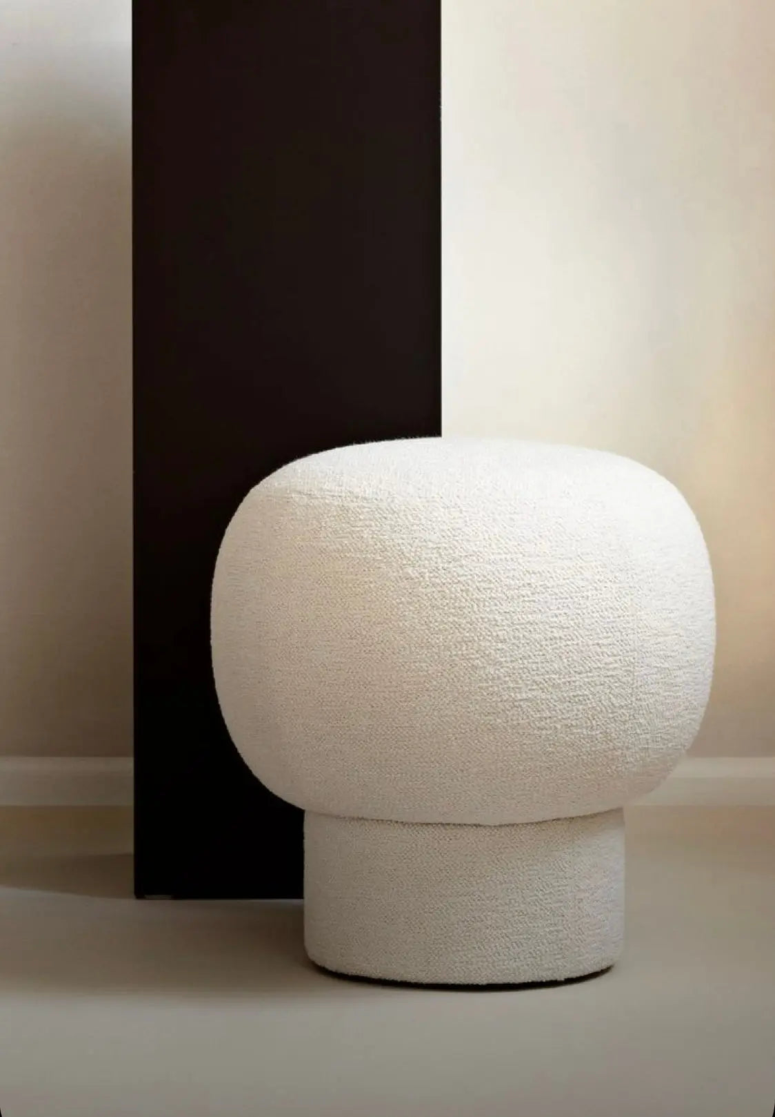 White textured ottoman on a neutral background