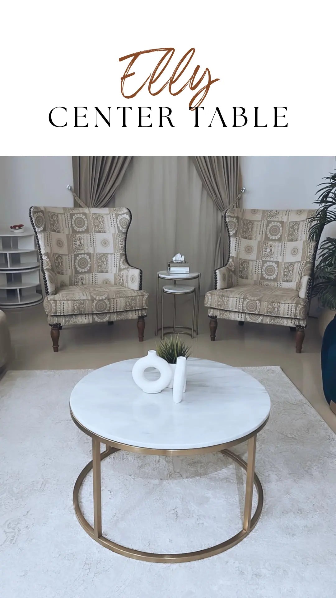 Round marble center table with gold frame in a living room setting, featuring 'Elly' branding.