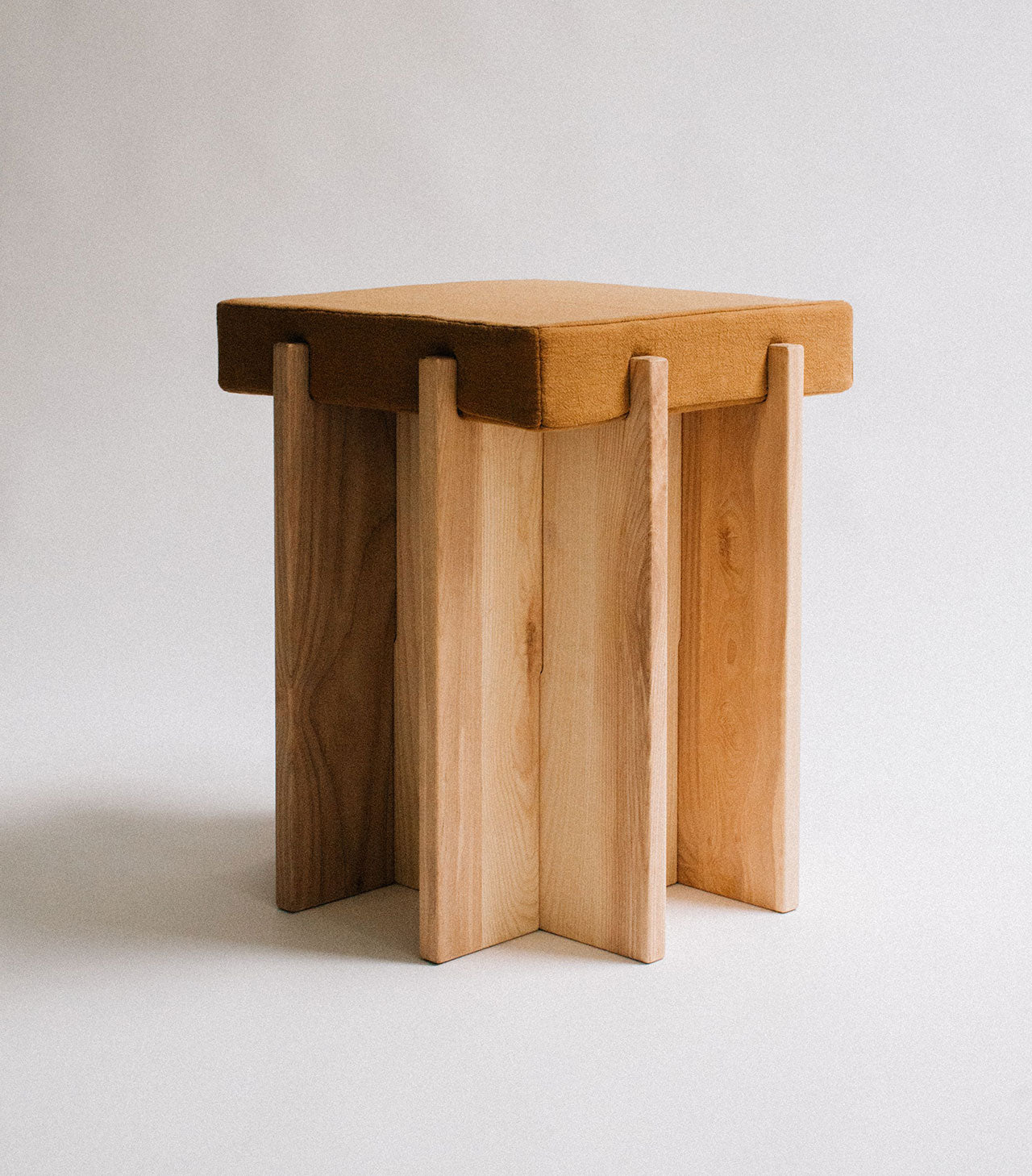 Wooden stool with a minimalist design on a light background