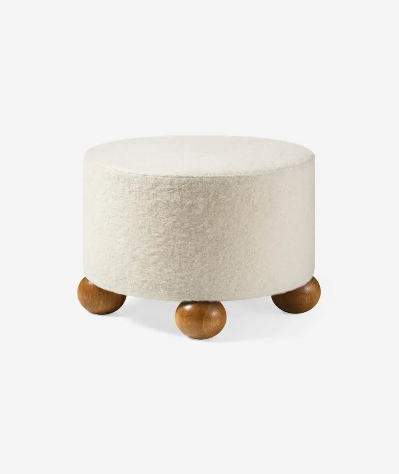 Round ottoman with wooden legs on a white background