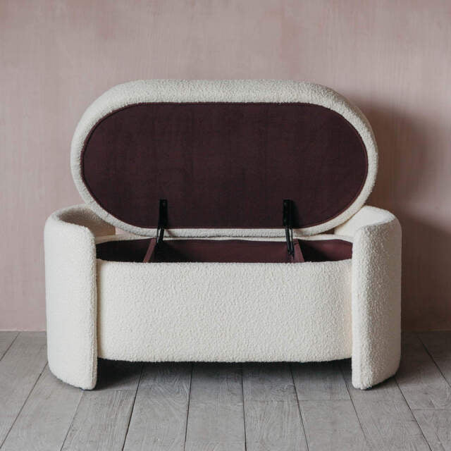 White textured storage bench with open lid against a pink wall