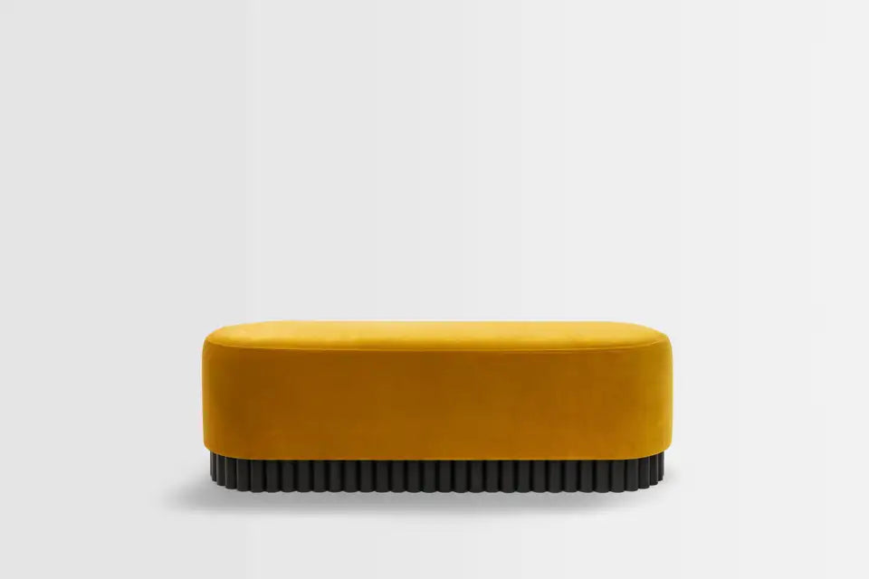 Mustard yellow bench with black base on a light gray background