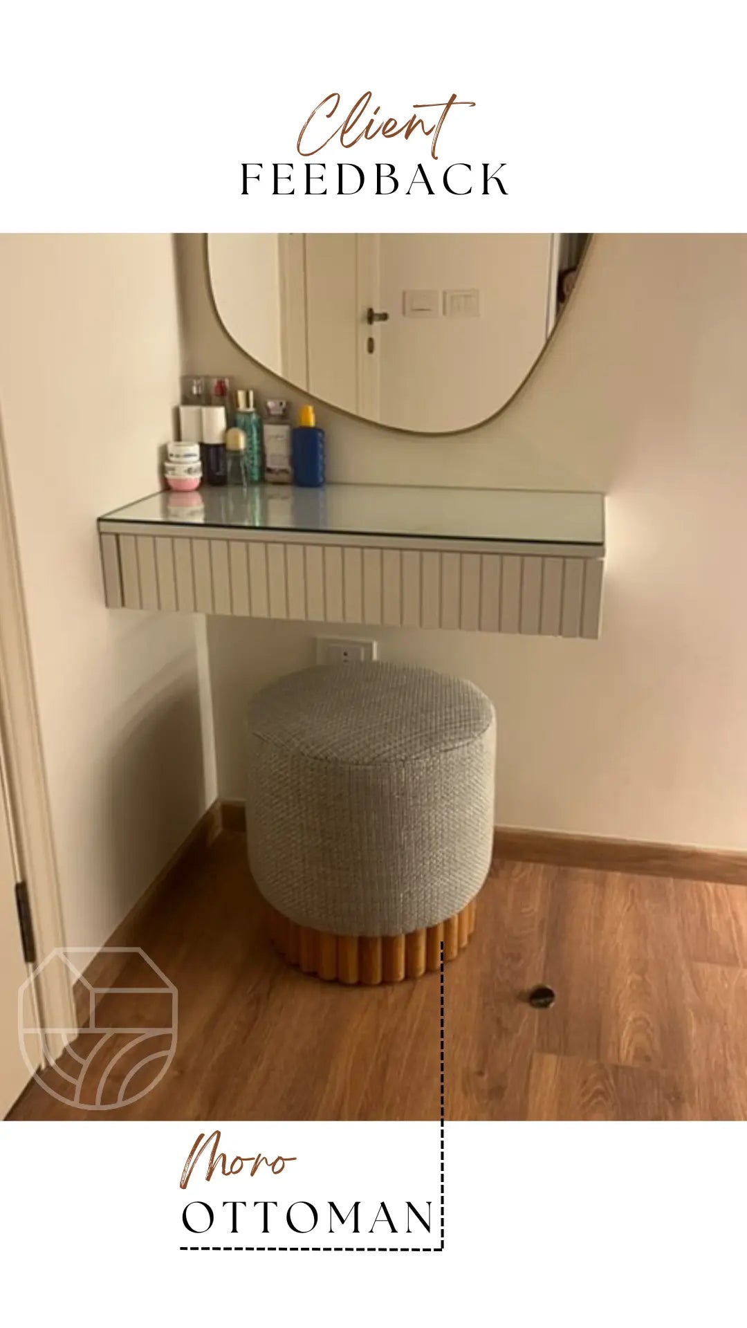 Gray ottoman in front of a vanity mirror with cosmetic products on a white wall.