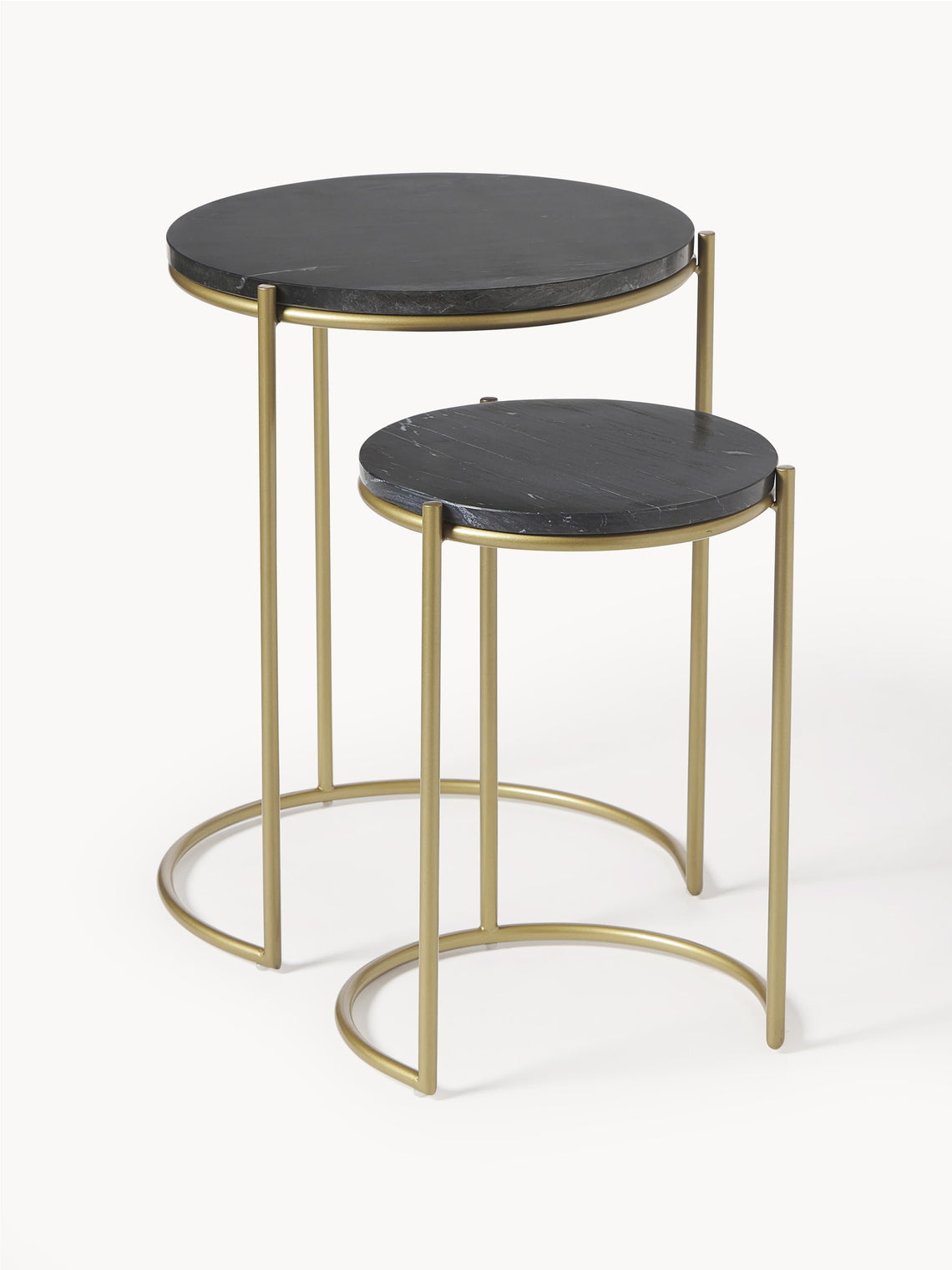 Set of two round side tables with black marble tops and gold metal frames on a white background
