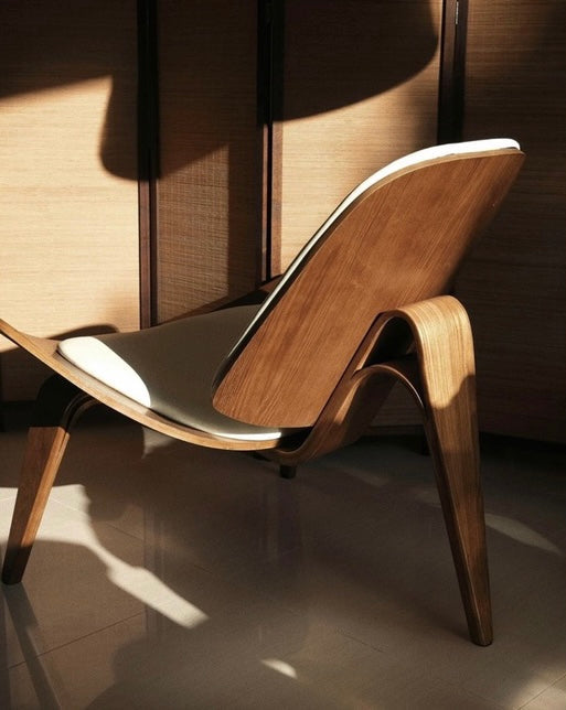 Wooden chair with a modern design in a softly lit room.