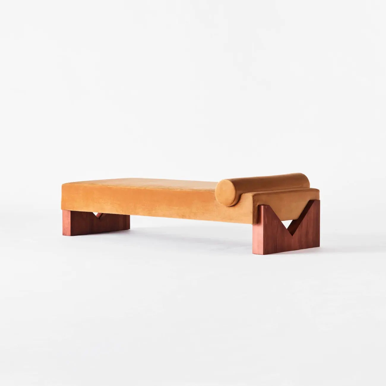 Modern bench with orange cushion and wooden legs on a white background