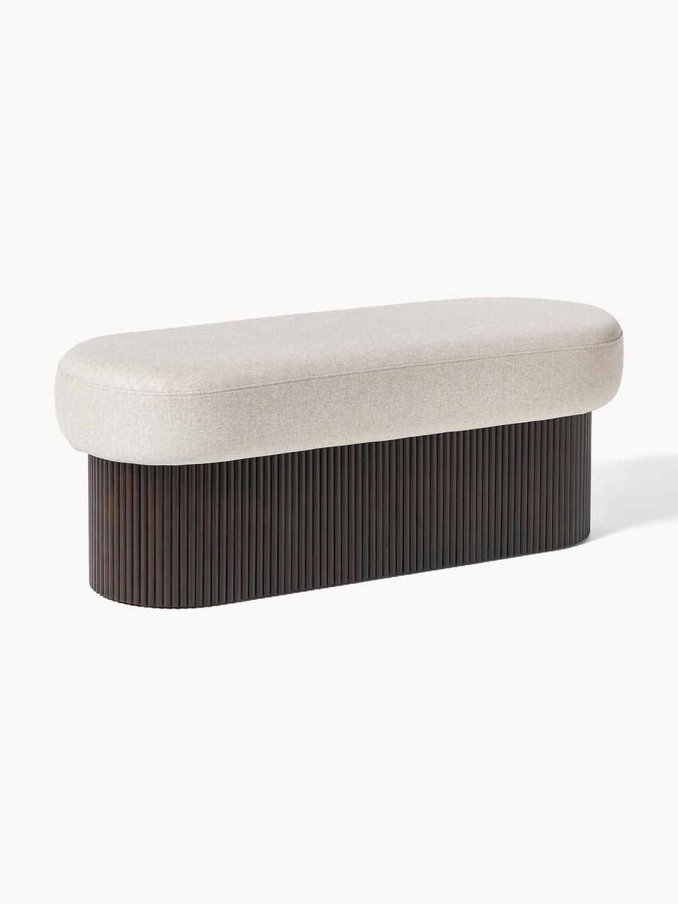 A modern bench with a gray cushioned top and a ribbed wooden base.