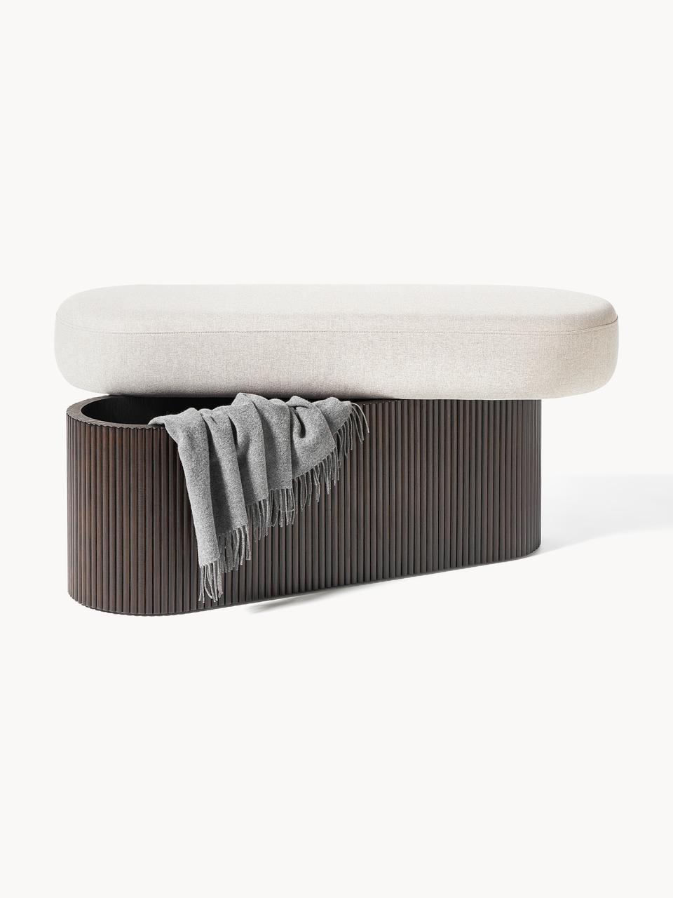 A modern bench with a gray cushioned top and a ribbed wooden base.